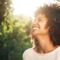 Close up portrait of beautiful confident woman laughing in nature